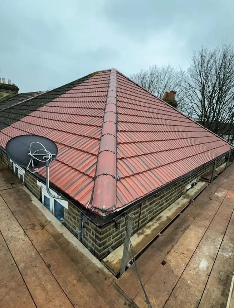 Hipped roof re-tiled with new red tiles